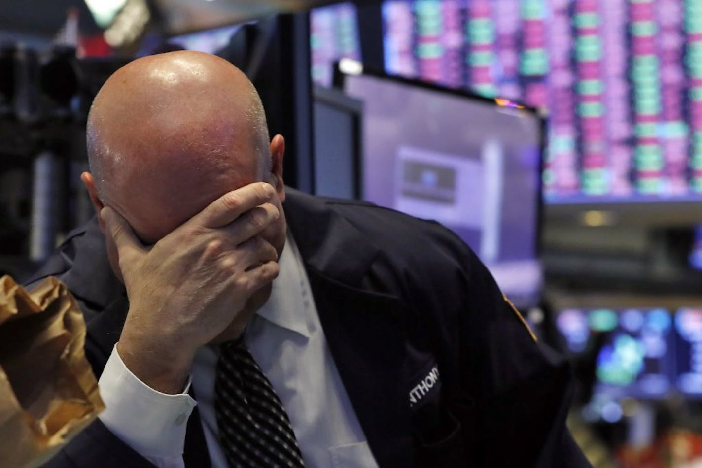 A trader has his head in his hand on the floor of the New York Stock Exchange, Thursday, March 12, 2020. The stock market had its biggest drop since the Black Monday crash of 1987 as fears of economic fallout from the coronavirus crisis deepened. The Dow industrials plunged more than 2,300 points, or 10%. The vast majority of people recover from the new coronavirus. According to the World Health Organization, most people recover in about two to six weeks, depending on the severity of the illness