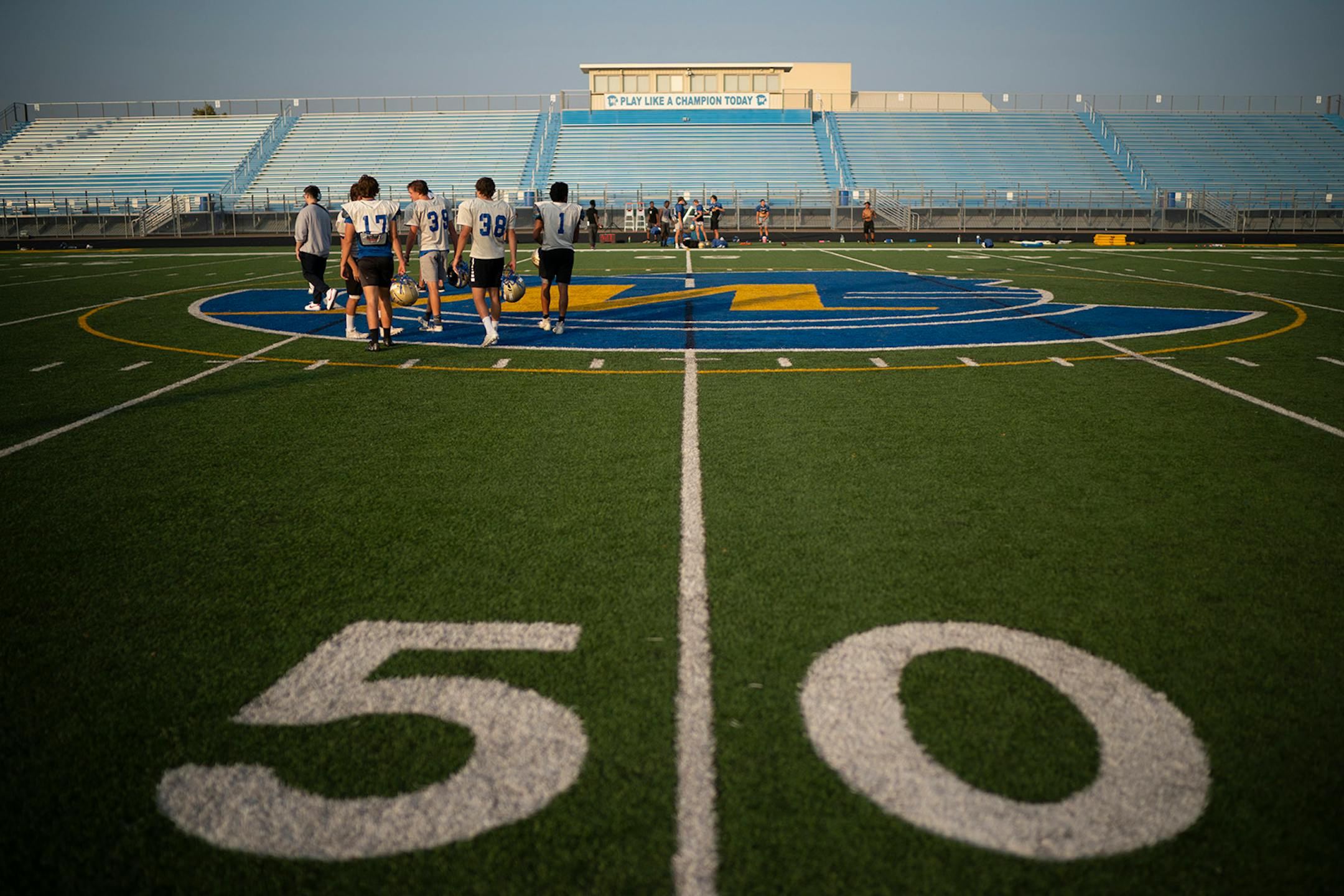 A pod of Wayzata football players walked off the field after a meeting after practice was over.