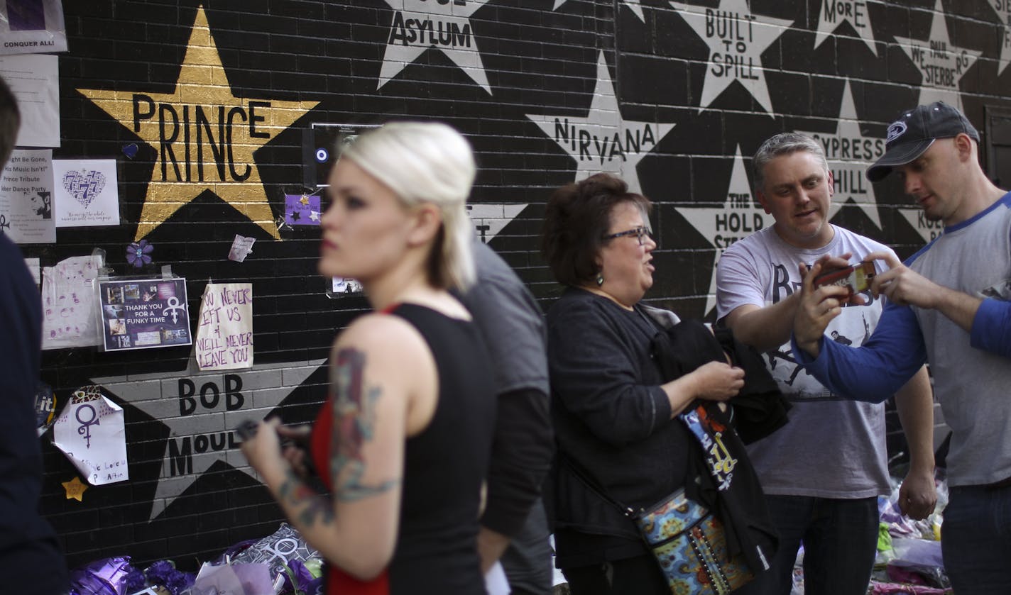 Prince's star on the wall of First Ave. was painted gold sometime overnight. ] JEFF WHEELER &#xef; jeff.wheeler@startribune.com A steady stream of Paul McCartney fans paused to view Princes's newly gold star on the wall outside First Ave. on their way to Target Center in Minneapolis Wednesday evening, May 4, 2016.