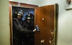 Riot police break into Rebeca Ferreruela's apartment to evict her and her family in Madrid, Spain, Wednesday, May 13, 2015. Rebeca Ferreruela 34, and 