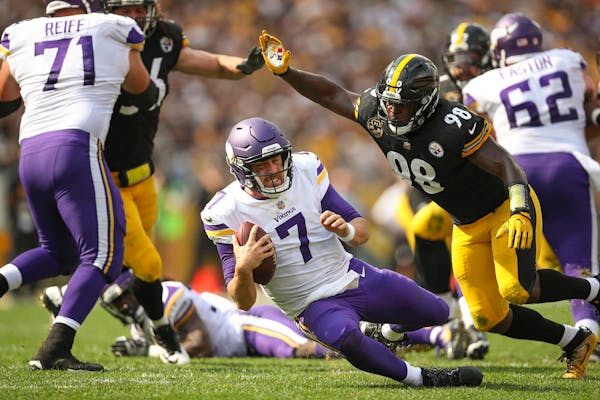 Minnesota Vikings quarterback Case Keenum (7) lost his footing while dropping back to pass in the third quarter and was smothered by Pittsburgh Steele
