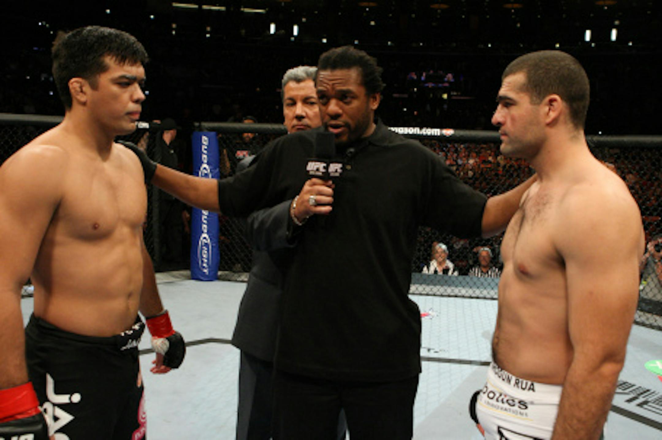 Referee Herb Dean (middle) gives instructions to Lyoto Machida (left) and Mauricio Rua (right) as announcer Bruce Buffer looks on (Photo courtesy of UFC)