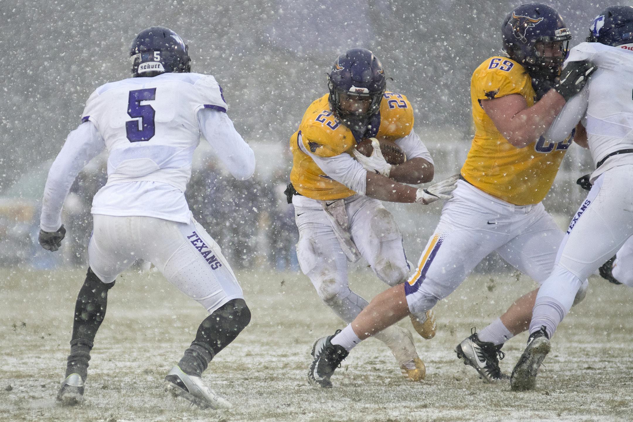 Minnesota State's Nate Gunn follows his blocker Evan Heim as Tarleton State's EJ Speed (5) looks to make a tackle on the play. Gunn carried the ball 50 times for 261 yards for the Mavericks in their win. Photo by Jackson Forderer