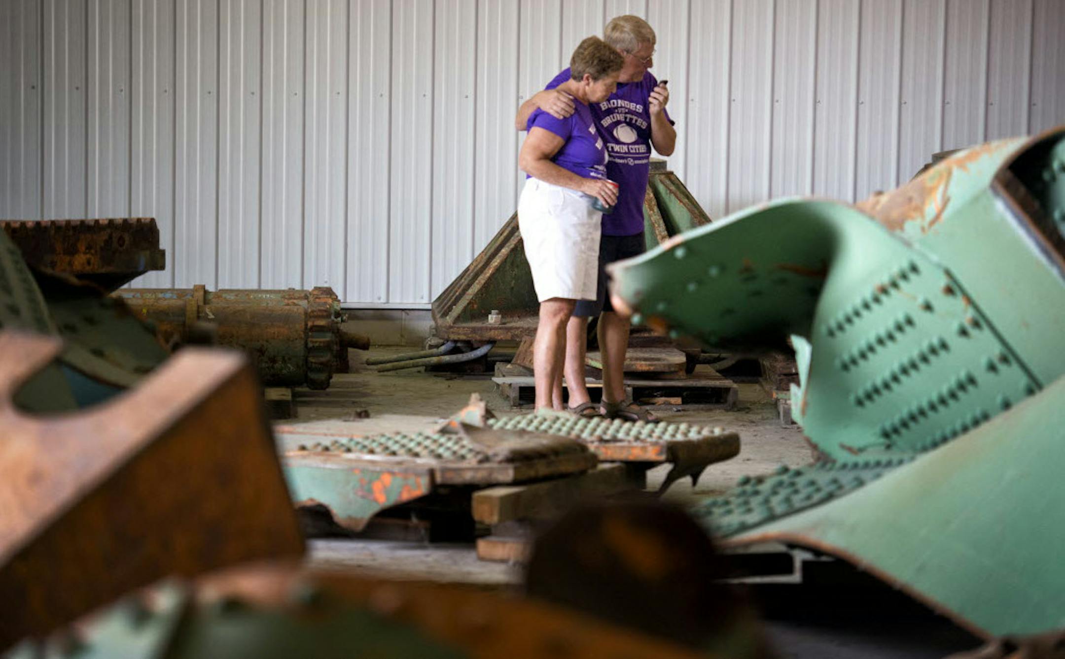 35W bridge collapse survivors Chris and Brent Olson looked over remnants of the bridge in the MnDOT storage facility in Oakdale.