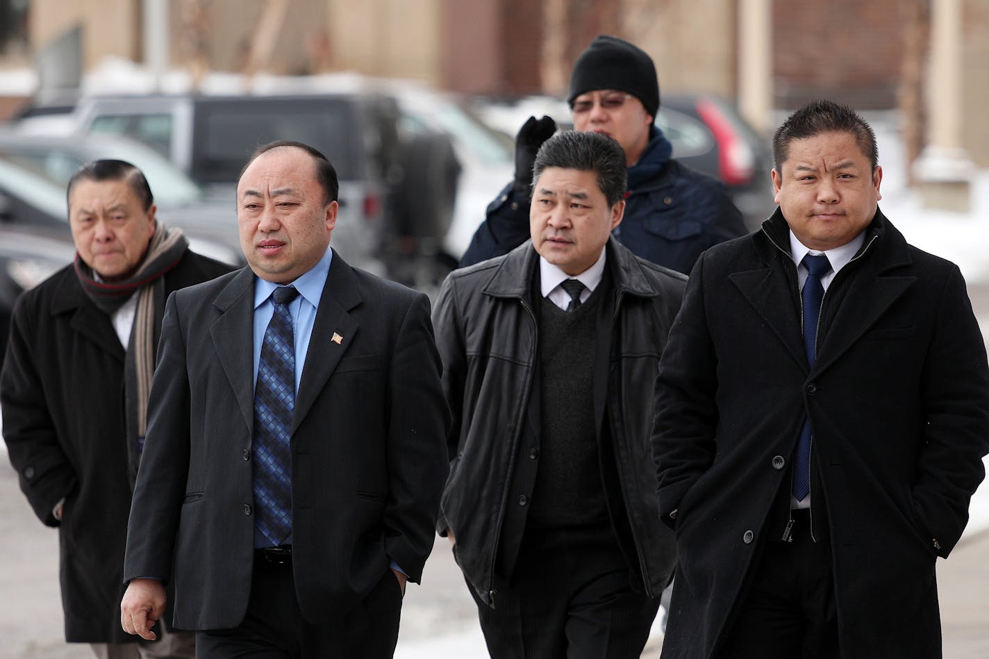 St. Paul City Council Member Dai Thao, right, walked with a group of men into the Ramsey County Law Enforcement Center for his hearing Tuesday. ] ANTHONY SOUFFLE &#xef; anthony.souffle@startribune.com St. Paul City Council Member Dai Thao made his first appearance in Ramsey County District Court Tuesday, March 6, 2018 in St. Paul, Minn. He has been charged with three misdemeanors for allegedly helping a woman vote while he was running for mayor.