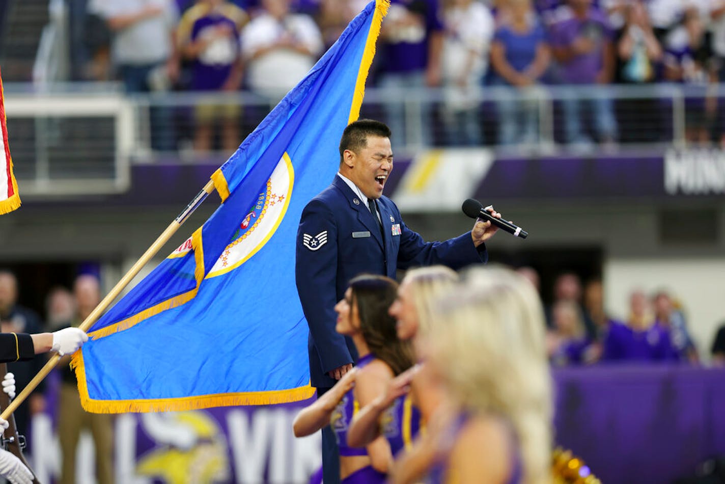 Mark J. Lindquist, a United States Air Force veteran of the Afghanistan War, sings the National Anthem during an NFL preseason football game between the Minnesota Vikings and Indianapolis Colts, Saturday, Aug. 21, 2021 in Minneapolis. Indianapolis won 12-10. (AP Photo/Stacy Bengs)