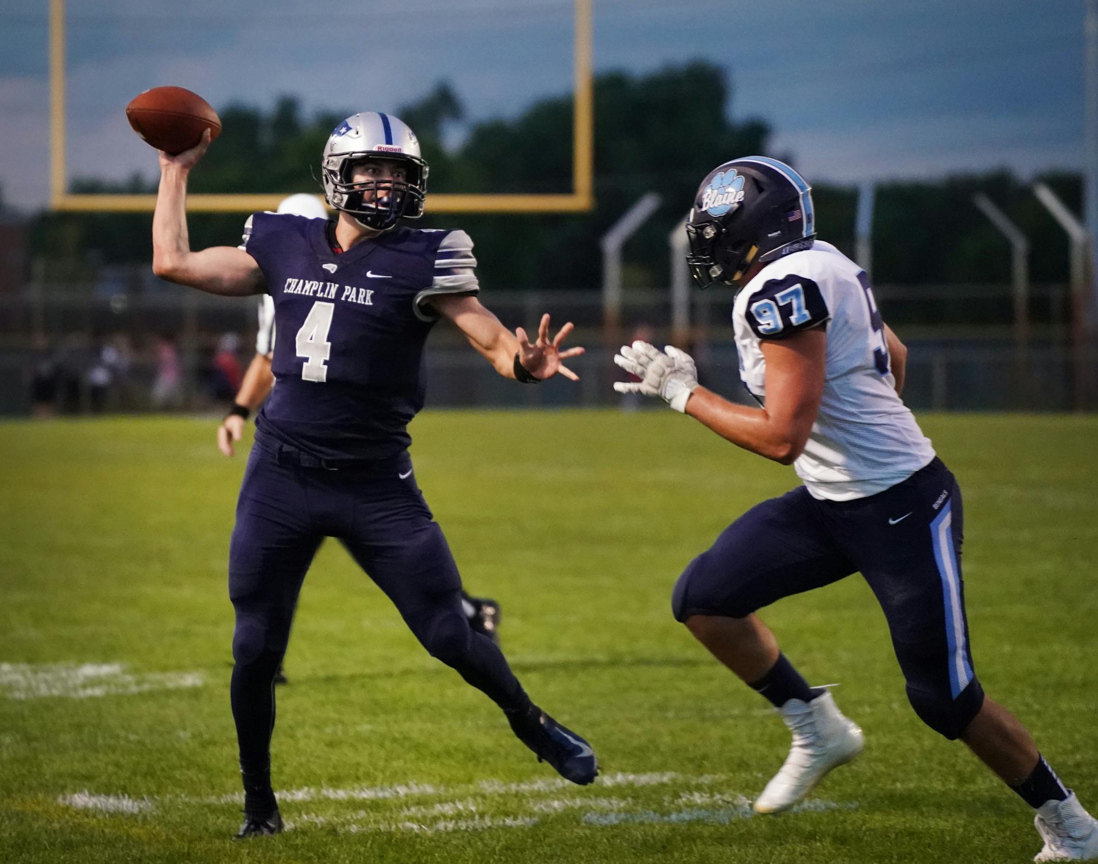 Champlin Park quarterback Jaice Miller (4) was pressured by Blaine defensive lineman Adam Brisson (97) in the first half. ] Shari L. Gross ¥ shari.gross@startribune.com The Champlin Park Rebels hosted the Blaine Bengals for a prep high school football game on Friday, Sept. 6, 2019.