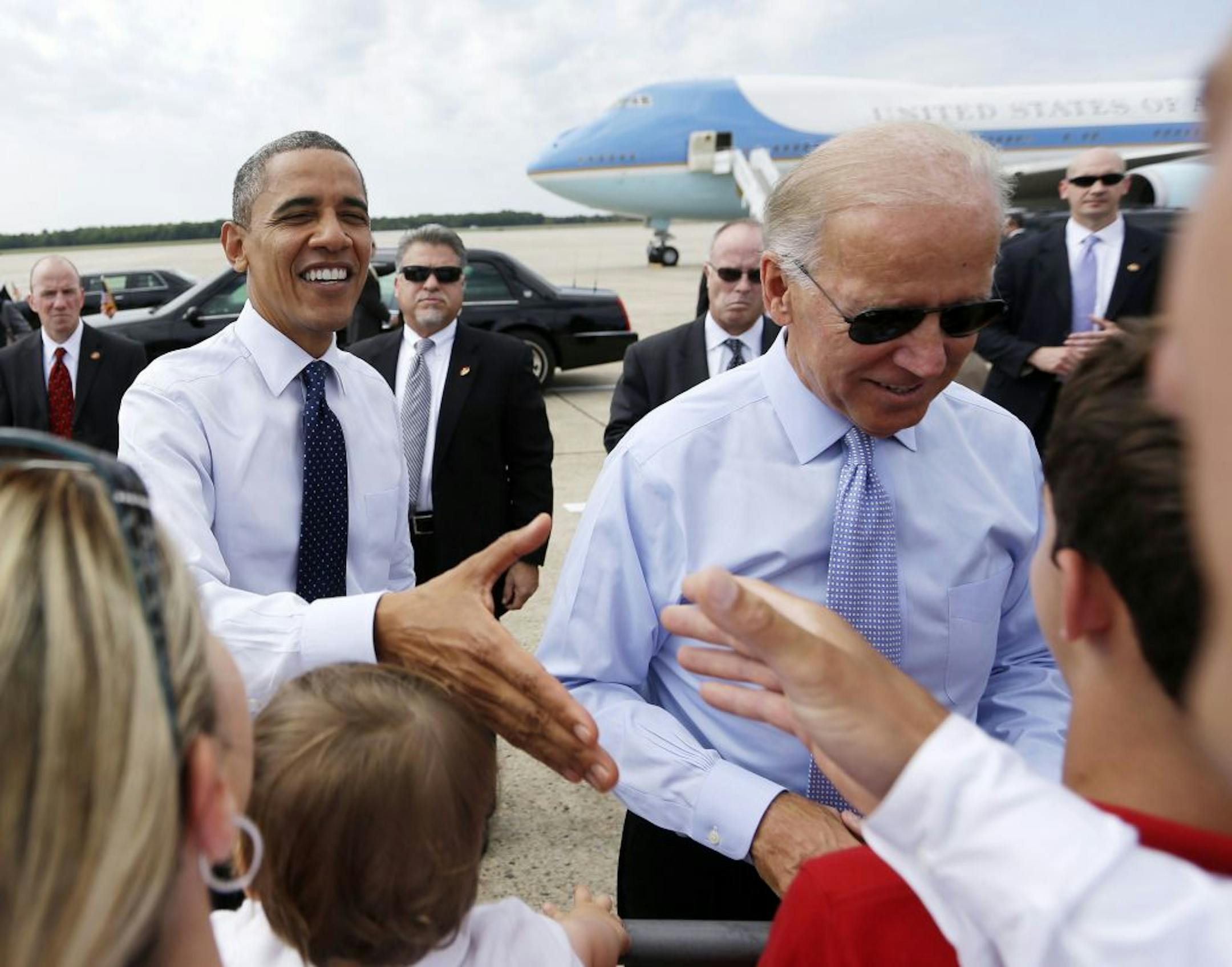 President Barack Obama and Vice President Joe Biden greet supporters on the tarmac upon their arrival at Portsmouth International Airport at Pease, Friday, Sept. 7, 2012, in Portsmouth, N.H.