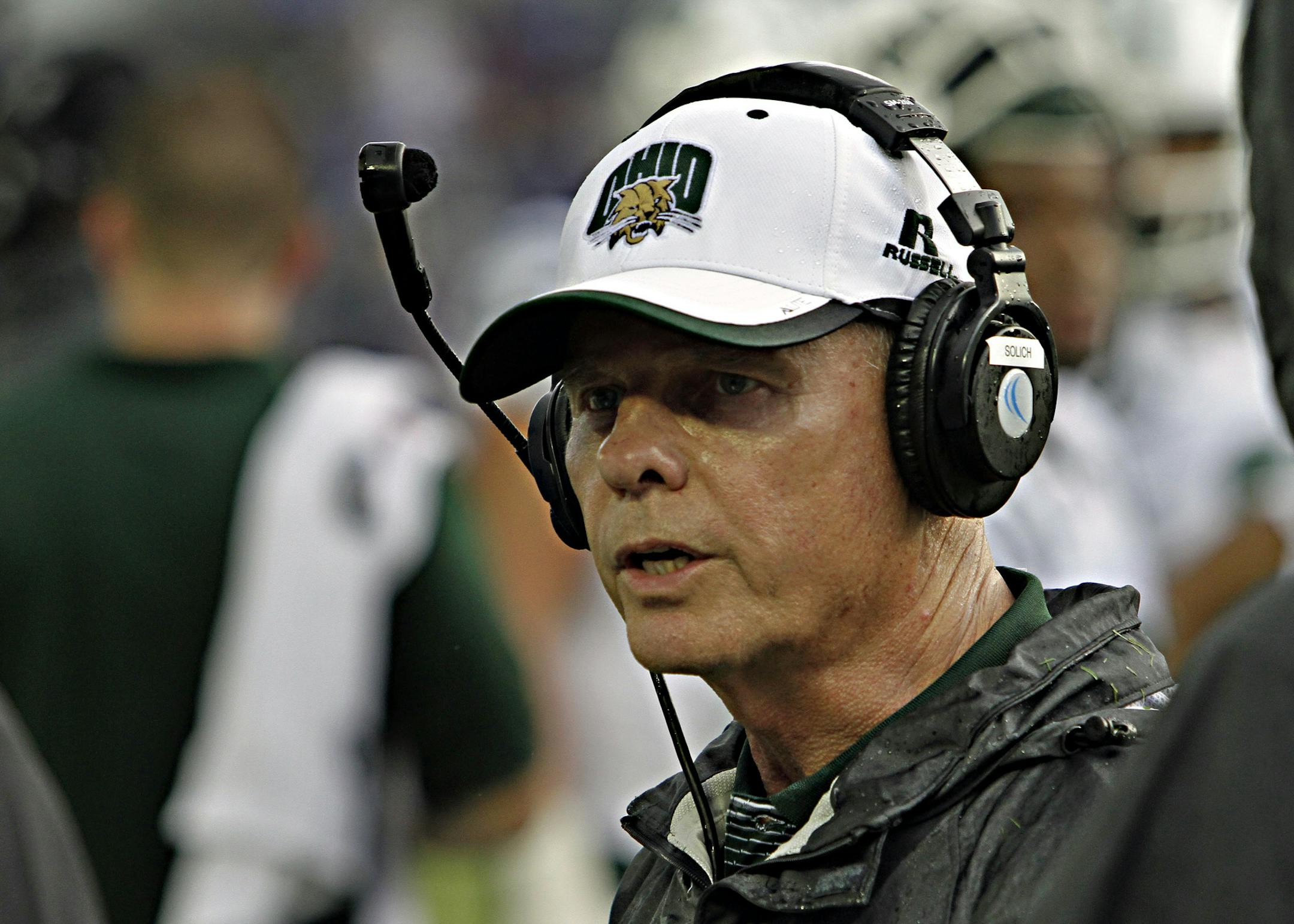 Ohio head coach Frank Solich talks with his staff on the sidelines in the NCAA college football game against Kentucky in Lexington, Ky., Saturday Sept. 6, 2014. Kentucky beat Ohio, 20-3. (AP Photo/Garry Jones) ORG XMIT: KYGJ111