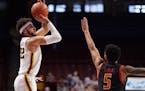 Minnesota guard Gabe Kalscheur (22) took an outside shot as Maryland guard Eric Ayala (5) reached to block in the first half. ] ANTHONY SOUFFLE • an