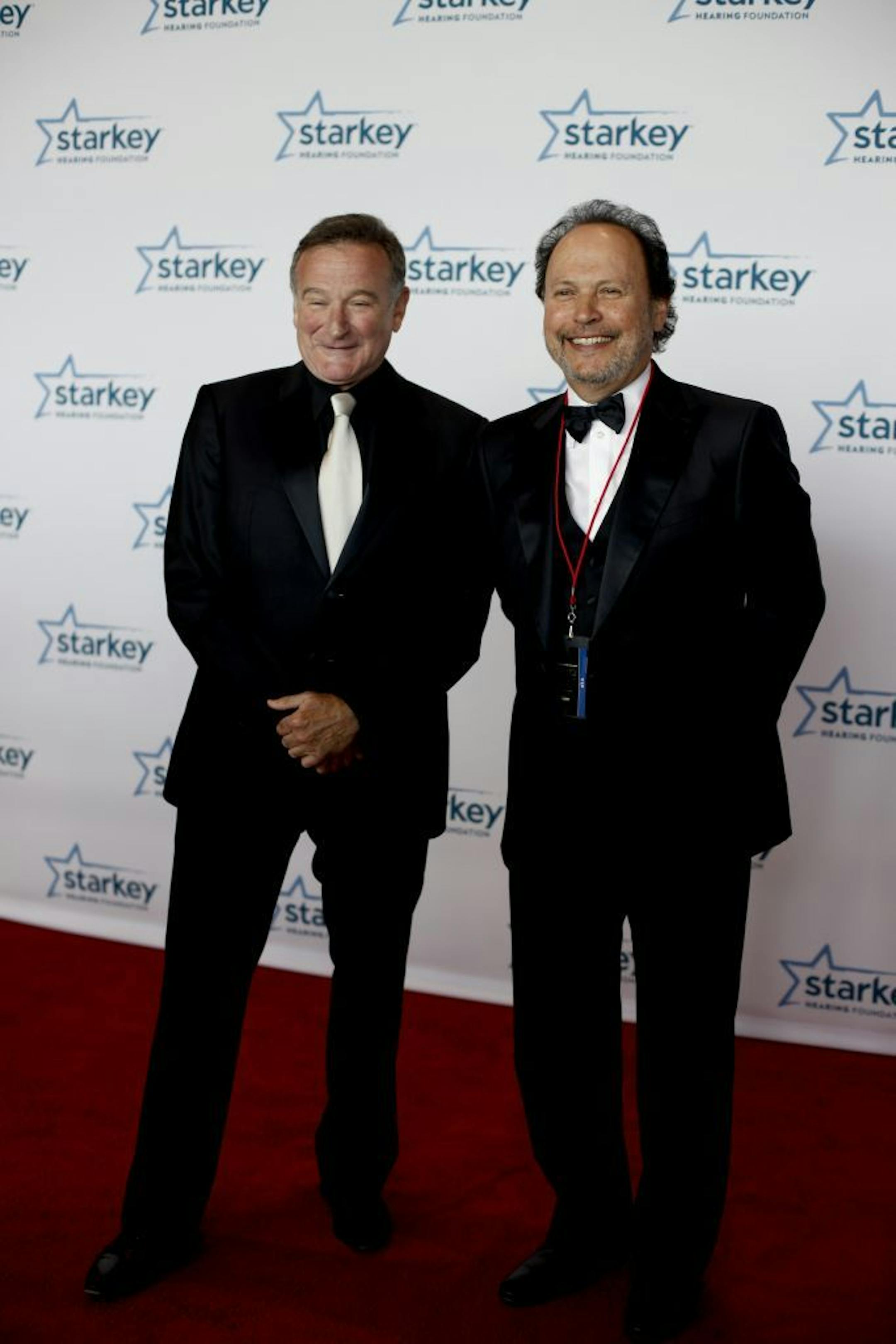 Robin Williams and Billy Crystal keep each other company as they pose for photos at the red carpet for the Starkey Hearing Foundation's 12th Annual "So the World May Hear" Awards Gala St. Paul, Minn. on Saturday, Aug. 4, 2012.