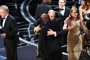 Confused Hollywood types on stage at the 2017 Oscars.