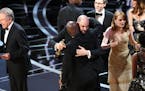 Confused Hollywood types on stage at the 2017 Oscars.