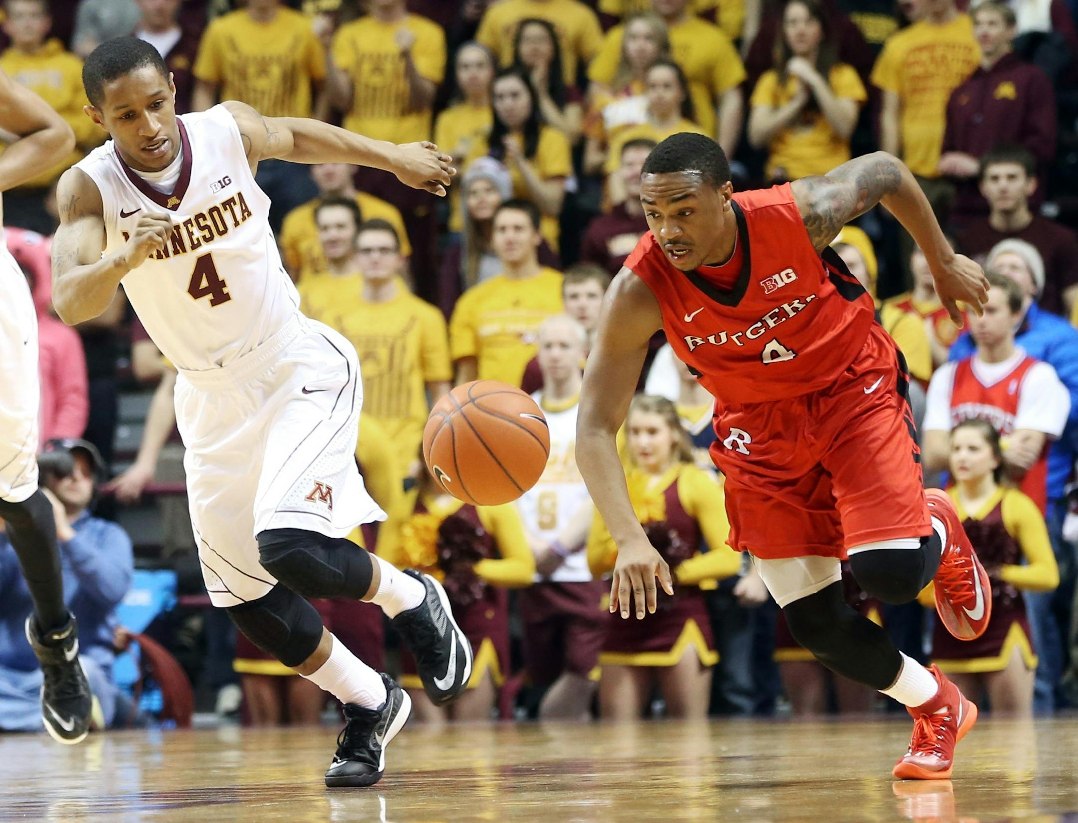 Rutgers&#x2019;s Myles Mack, right, and Minnesota&#x2019;s DeAndre Mathieu chase after the ball during the first half of an NCAA college basketball game, Saturday, Jan. 17, 2015, in Minneapolis. (AP Photo/Jim Mone)