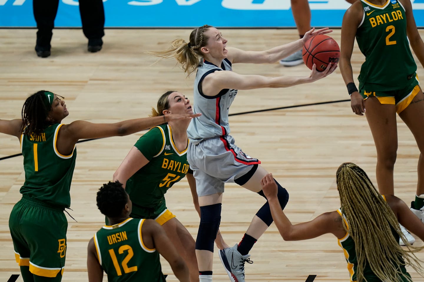 UConn guard Paige Bueckers , center, drives to the basket against Baylor during the first half of a college basketball game in the Elite Eight round of the women's NCAA tournament at the Alamodome in San Antonio, Monday, March 29, 2021. (AP Photo/Eric Gay)