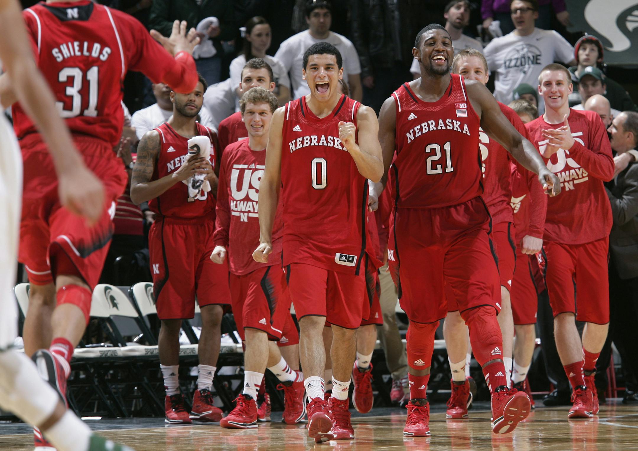 Nebraska players, including Shavon Shields (31), Tai Webster (0) and Leslee Smith (21 celebrate their 60-51 win over Michigan State in an NCAA college basketball game, Sunday, Feb. 16, 2014, in East Lansing, Mich. (AP Photo/Al Goldis)