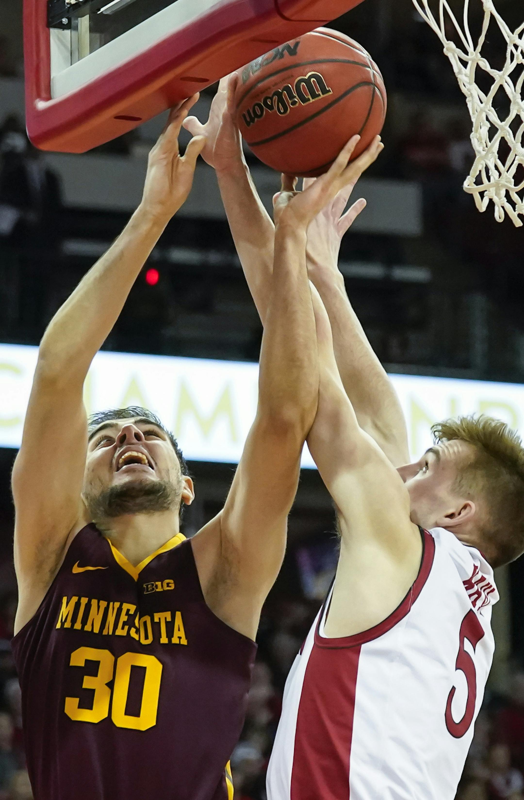 Minnesota's Alihan Demir (30) shoots against Wisconsin's Tyler Wahl (5) during the first half of an NCAA college basketball game Sunday, March 1, 2020, in Madison, Wis. (AP Photo/Andy Manis)