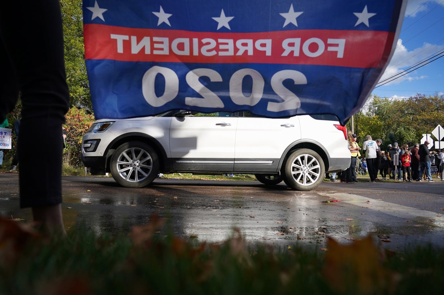 Supporters and opponents of President Trump lined the streets of Shorewood, Minn. near the home of Marty Davis, where Trump held a private fundraiser on Wednesday, Sept. 30, 2020.