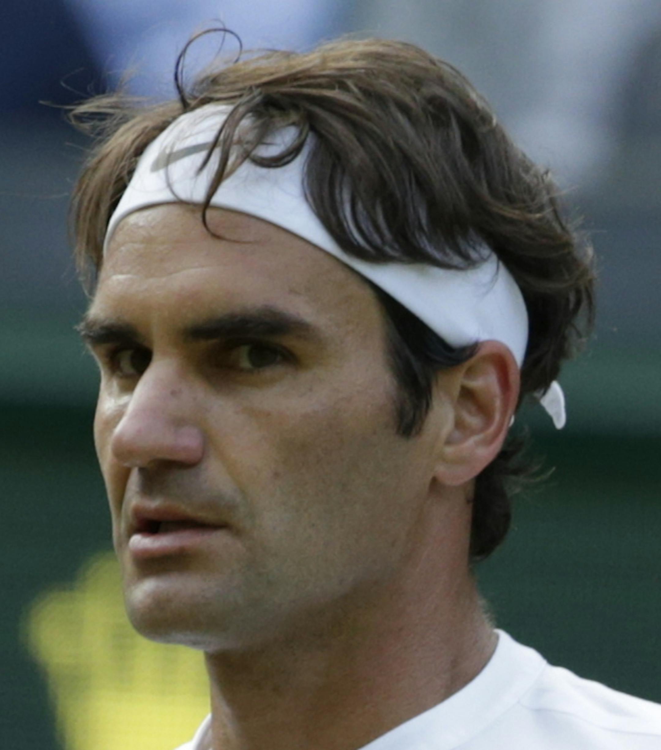 Roger Federer of Switzerland wins a point against Roberto Bautista Agut of Spain during their singles match against, at the All England Lawn Tennis Championships in Wimbledon, London, Monday July 6, 2015. (AP Photo/Alastair Grant)