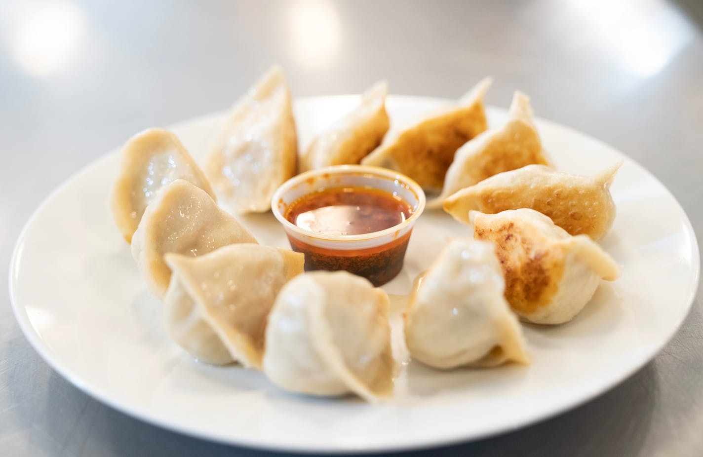 Freshly cooked dumplings from Saturday Dumpling Co. are plated Thursday, May 11, 2023, at Dots Gray Kitchen in Minneapolis.