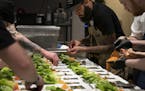 Chef and Top Chef contestant Justin Sutherland assembled a salad in the kitchen for a six course meal at the Handsome Hog in St. Paul, Minn., on Thurs