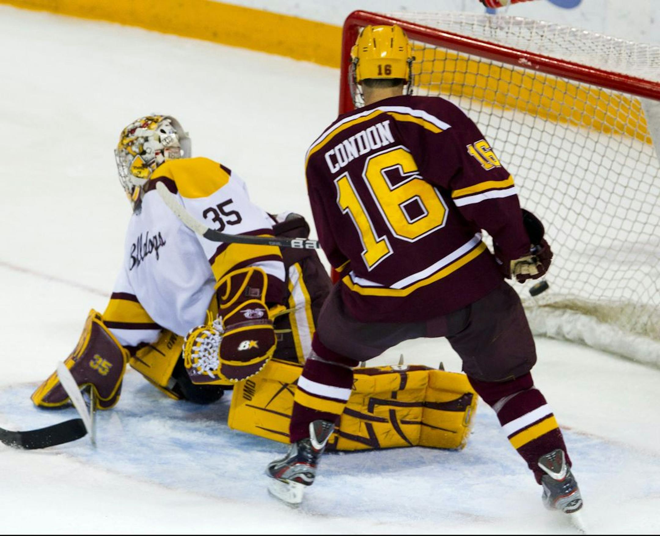 Minnesota's Nate Condon watches his game-winning shot get past Minnesota Duluth goaltender Kenny Reiter late in overtime Friday evening at Amsoil Arena in Duluth, Minn.