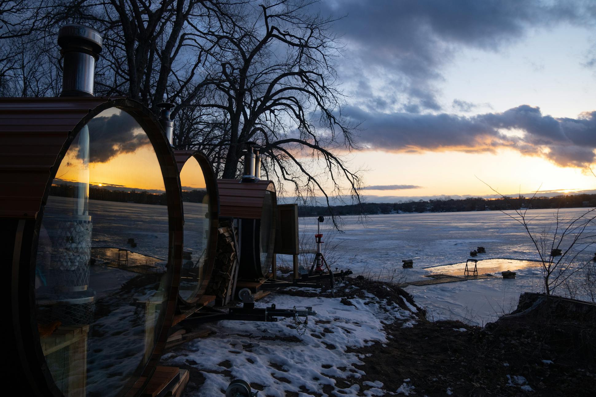 The sunset over Lake Minnewashta is reflected in wood-fired cedar saunas at Sauna Camp in Excelsior. “It’s taken off,” said Danny Strauss, 32, who left a corporate career to launch the camp with his wife, 29, who owns a video production company. “Being outside, no phones, in a sauna feeling good, doing something hard and challenging together, it’s all just an environment that’s ... really conducive to connecting and letting go.”