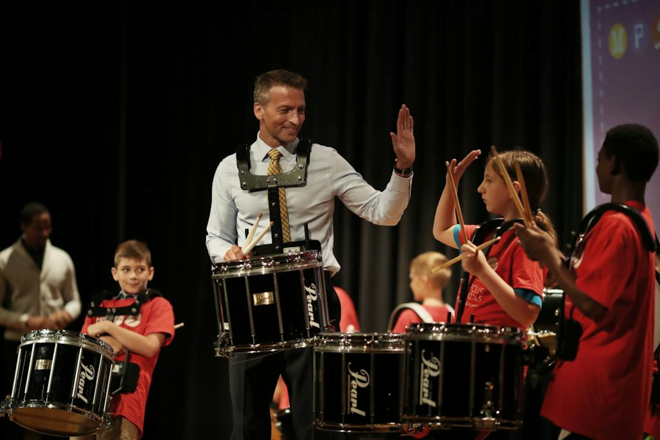 Minneapolis school Superintendent Ed Graff, left high-fived Jonah Gunderman a member of the Gems and Gise drum group after giving his State of the Schools address Monday August 20, 2018 at North Community High School in Minneapolis, MN.