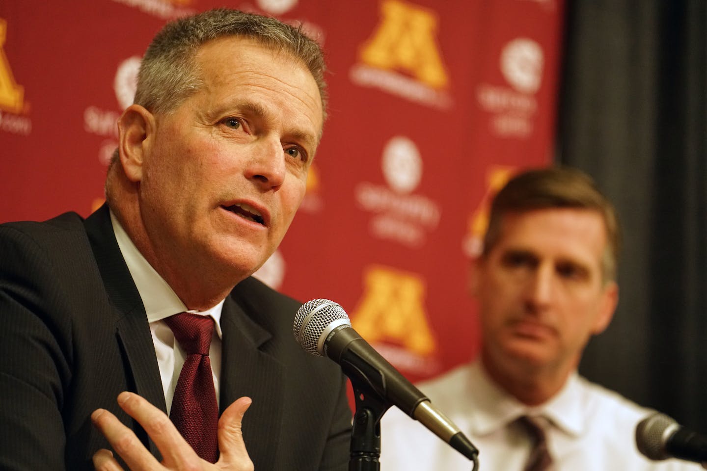 Don Lucia on Tuesday announced he is stepping down as Gophers men's hockey coach after 19 seasons. At right is U of M Athletics Director Mark Coyle.