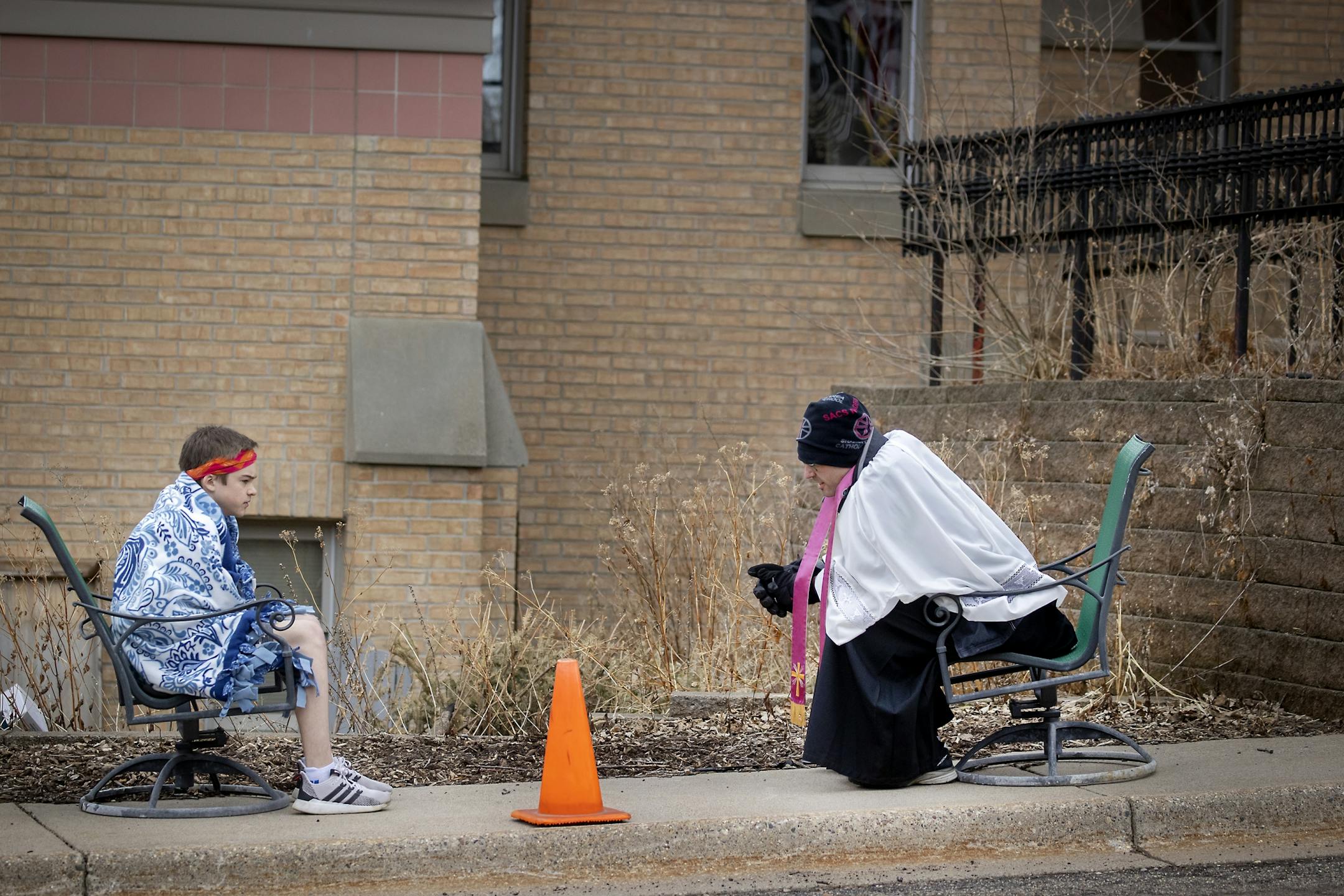 The Rev. Erik Lundgren listened to confessions outside Sts. Joachim & Anne Catholic Church in Shakopee on Wednesday, an adaptation made to cope with COVID-19.