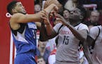 Minnesota Timberwolves center Karl-Anthony Towns (32) and Houston Rockets center Clint Capela (15) struggle for the ball during the second half of an 