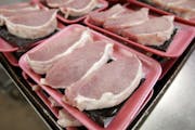 FILE - This March 3, 2011 file photo shows boneless pork loins waiting to be packaged at a local Dahl's grocery store in Des Moines, Iowa. The America