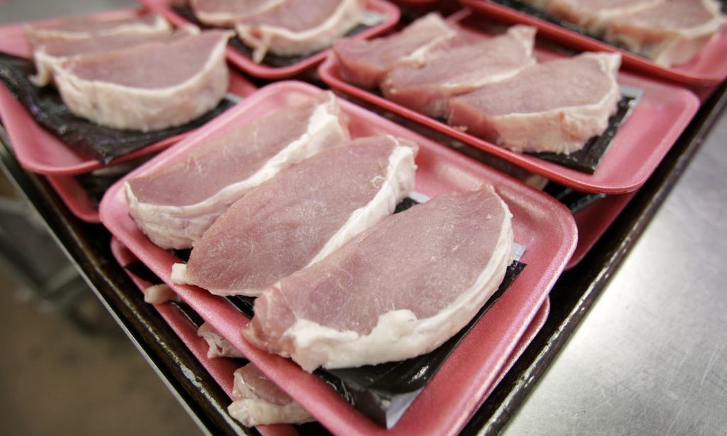 FILE - This March 3, 2011 file photo shows boneless pork loins waiting to be packaged at a local Dahl's grocery store in Des Moines, Iowa. The American meat industry is rolling out a refresh of the often confusing 40-year-old system used for naming the various cuts of beef, pork, lamb and veal. That's because the system was designed more for the needs of retailers and butchers than for the convenience of harried shoppers more familiar with Shake 'n Bake than boneless shank cuts.