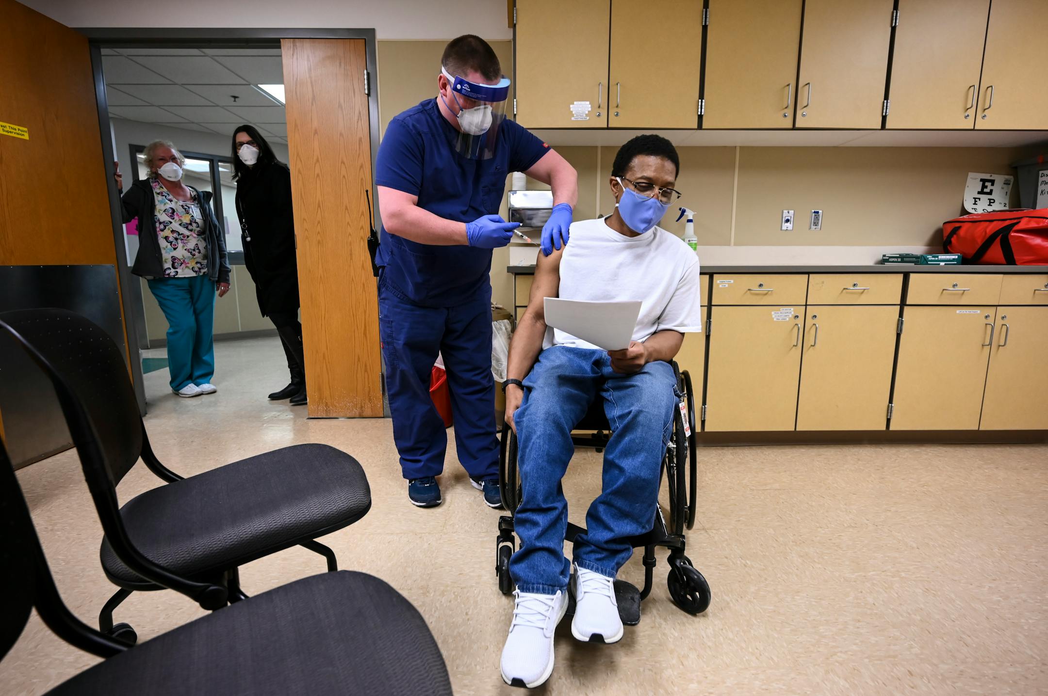 Kelly Markham, an RN supervisor at Faribault Prison, administered the state's first COVID-19 vaccination to a medically vulnerable inmate, Edward Anderson.
