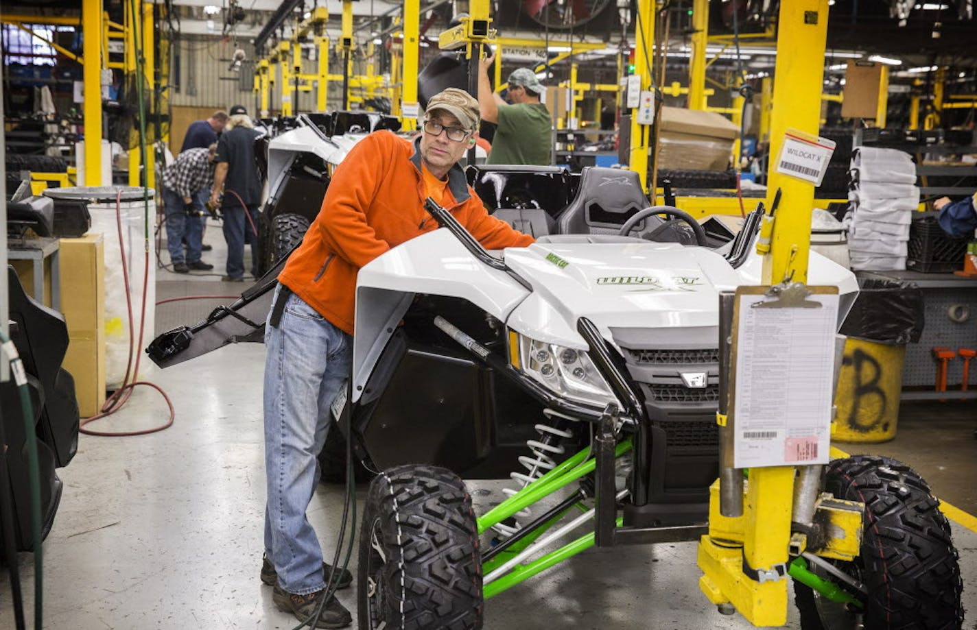 A factory worker assembles the 2016 Wildcat X side-by-side vehicle in the Arctic Cat factory in Thief River Falls on Wednesday, September 30, 2015. ] LEILA NAVIDI leila.navidi@startribune.com / BACKGROUND INFORMATION: Arctic Cat management did not allow the photographer to get any names of the workers.