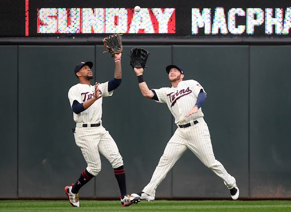 Minnesota Twins center fielder Byron Buxton (25) and right fielder Robbie Grossman (36) collided as they chased down a fly ball, caught by Buxton