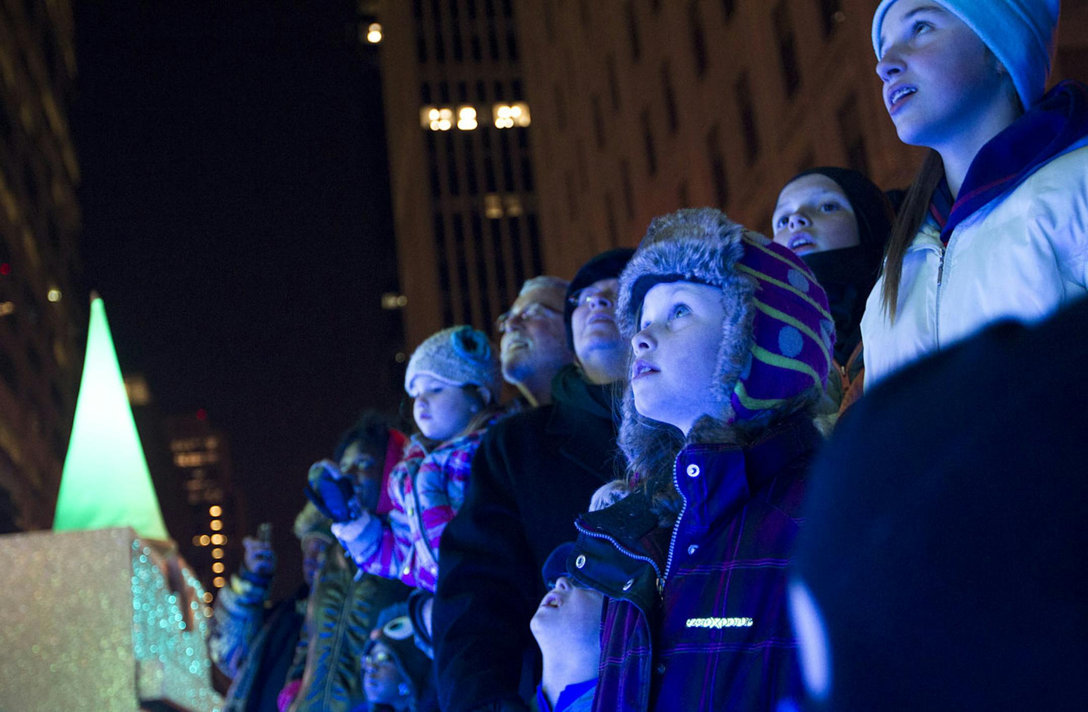 Spectators gaze at the lights on the first night of the 2013 Target Holidazzle parade on Nicollet Mall in Minneapolis November 29, 2013. (Courtney Perry/Special to the Star Tribune)