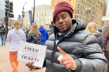 Ronnell Harris, a native of Kansas City, held a sign reading “I NEED TICKETS” across the street from Target Center.