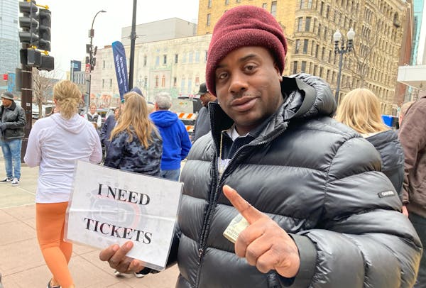 Ronnell Harris, a native of Kansas City, held a sign reading “I NEED TICKETS” across the street from Target Center.