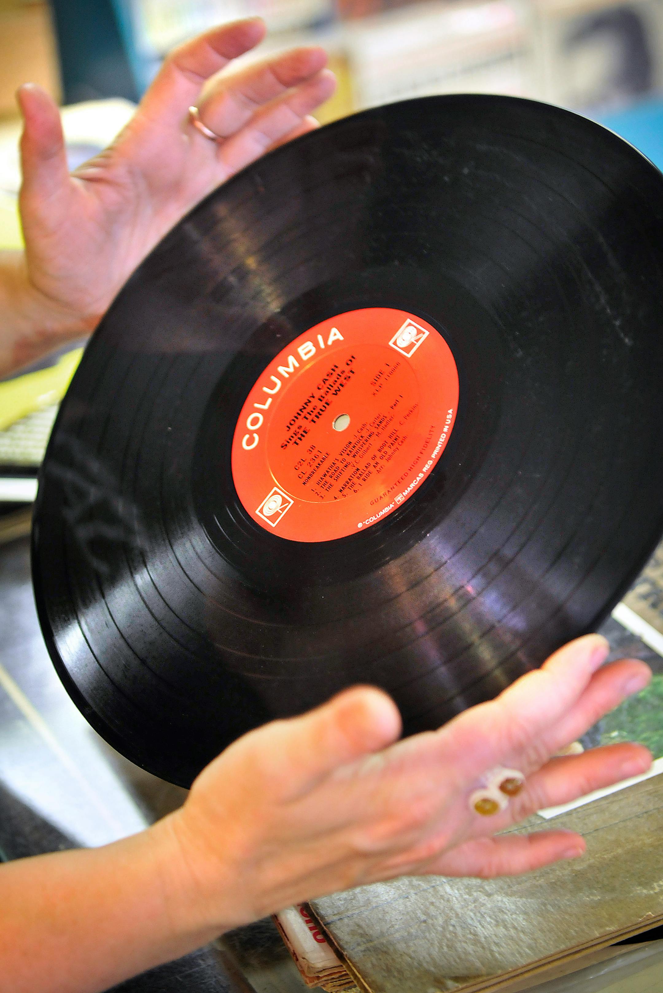 Hymie's co-owner Auralee Likes inspected a Johnny Cash record before putting it on the sales shelf. "Rap is somewhat responsible for keeping vinyl records around, because the DJs use vinyl," Likes said.