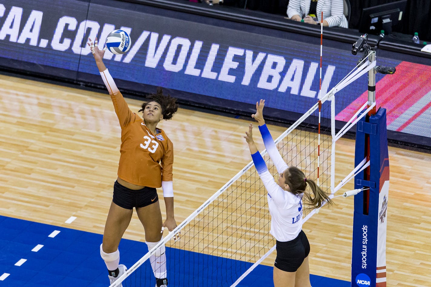 Texas' Logan Eggleston (33) hits the ball against Kentucky's Madison Lilley (3) in the first set during the finals in the NCAA women's volleyball championships Saturday, April 24, 2021, in Omaha, Neb. (AP Photo/John Peterson)