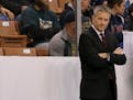 Minnesota head coach Don Lucia looks on from the bench before the start of an NCAA regional men�s college hockey tournament game against Notre Dame,