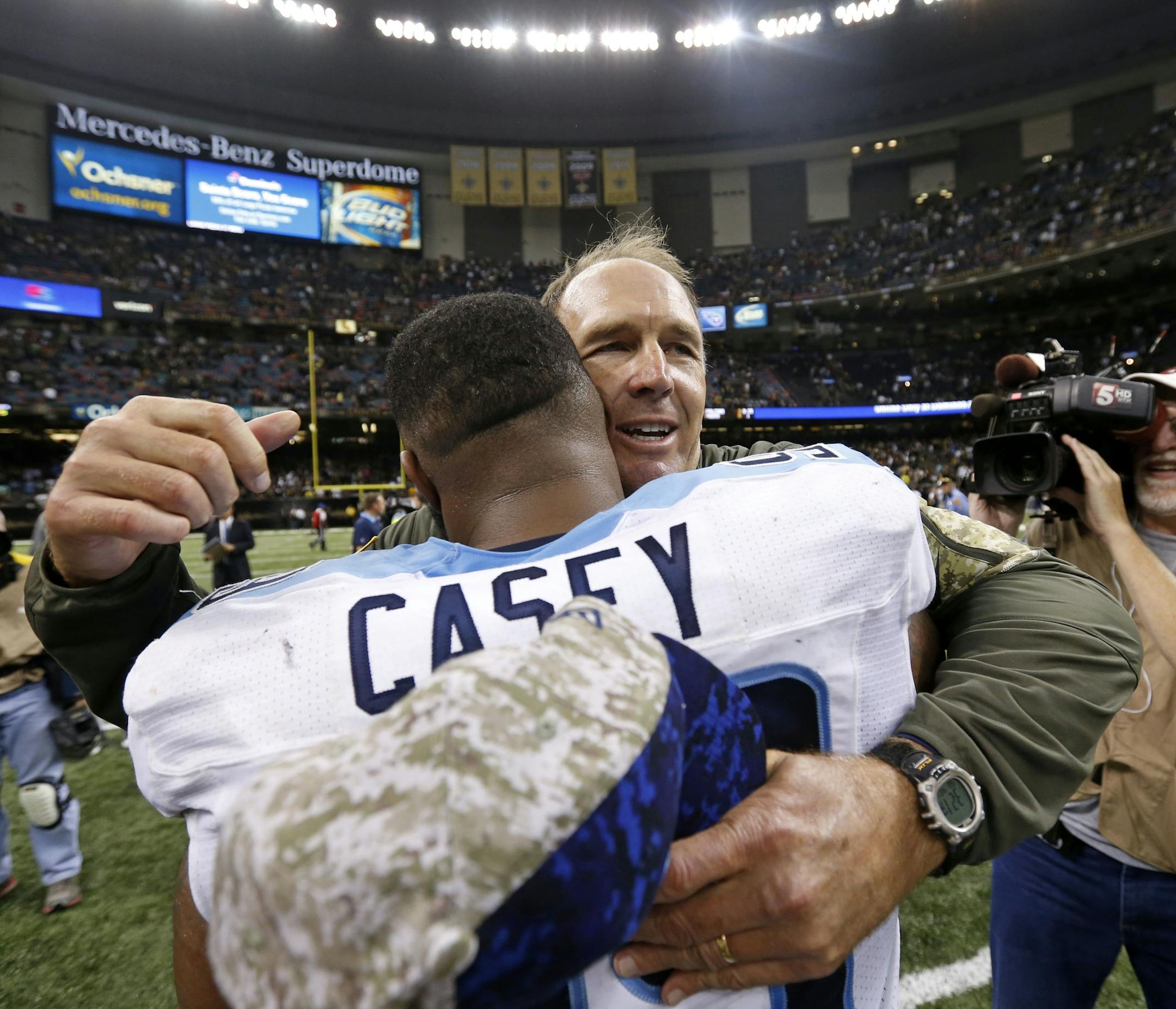 Tennessee Titans interim head coach Mike Mularkey hugs defensive end Jurrell Casey after their overtime victory over the New Orleans Saints in an NFL football game in New Orleans, Sunday, Nov. 8, 2015. The Titans won 34-28. (AP Photo/Jonathan Bachman)