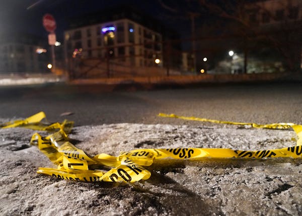 Police tape was crumpled on the ground on 29th Street near S. Colfax Avenue in Minneapolis.