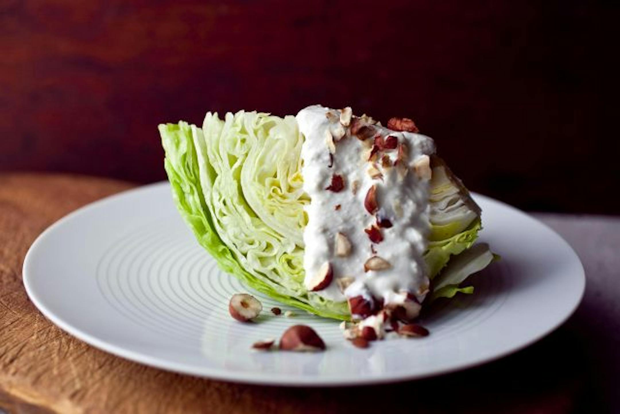 A wedge of iceberg lettuce with blue cheese yogurt dressing photographed March, 2010. Romaine and iceberg lettuce are two standbys available nationwide and are especially useful through winter and spring, while waiting for mesclun to arrive.