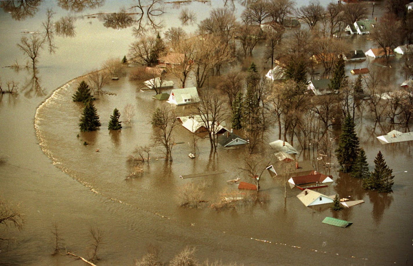 The dike holding back the Red River gave way on April 18, 1997, flooding homes up to the rooftops.