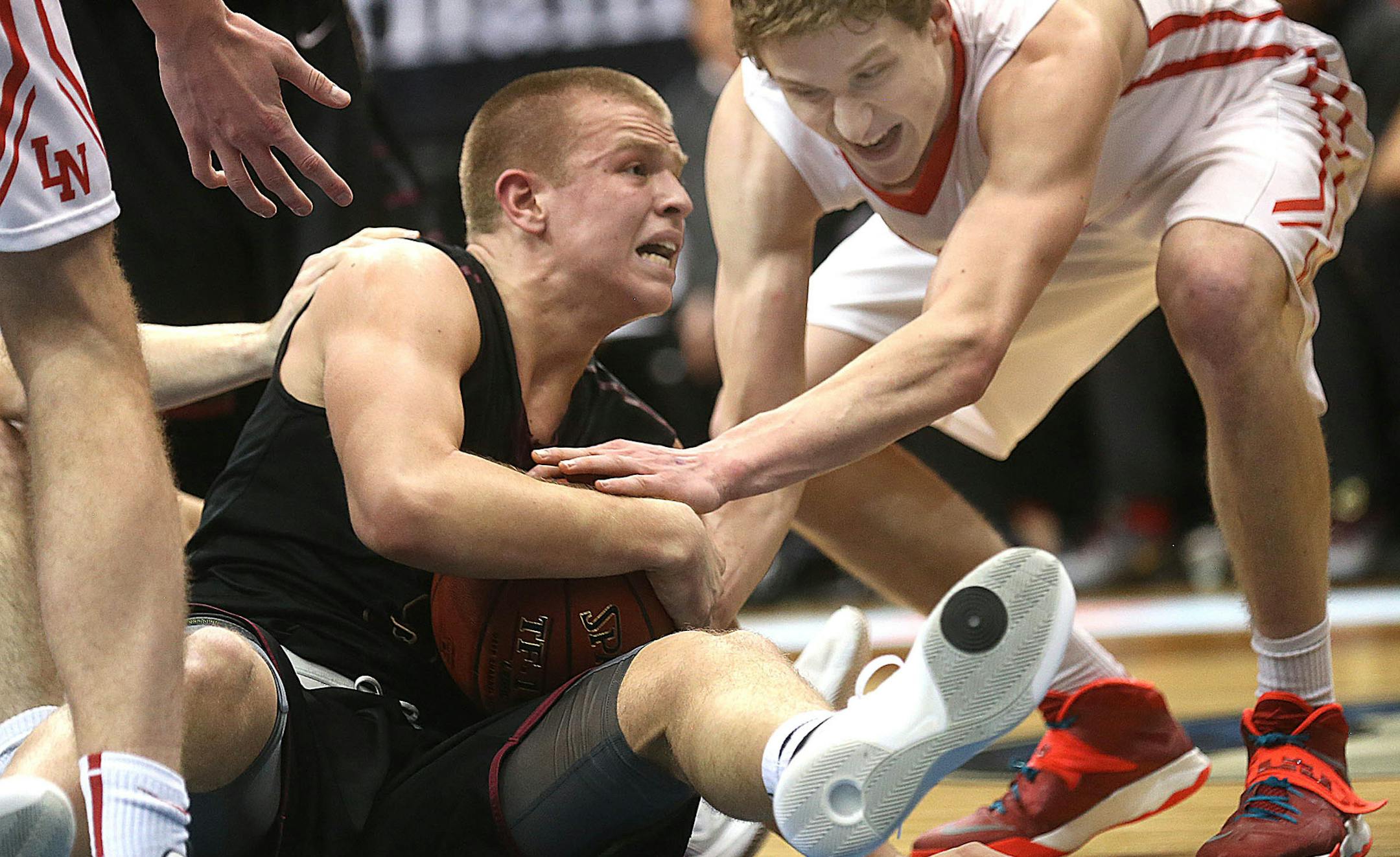 Lakeville Northís Nathan Reuvers(behind) and Maple Groveís Brad Davison wrestled for control of a loose ball.] JIM GEHRZ ï james.gehrz@startribune.com /Minneapolis, MN / March 9, 2016 /10:00 AM; 12:00 and 2 PM ñ BACKGROUND INFORMATION: Class 4A boys' basketball quarterfinals of the 2016 State Basketball Tournament at Target Center.#1 Osseo vs Eden Prairie, 10 a.m. Osseo won the game, 85-73;#4 Maple Grove vs #5 Lakeville North, noon. Lakeville North won the game, 60-49.;#2 Hop