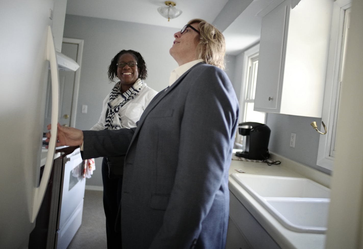 Realtor Kath Hammering shows Latisha Lowe the merits of a starter home in Crystal listed in the 170,000's . This would Lowe's first home. ]Richard Tsong-Taatarii &#xef; richard.tsong-taatarii@startribune.com