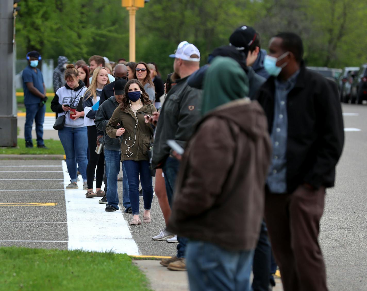 Fourteen DVS exam stations reopened Tuesday, including this one in Arden Hills where during the mid-morning an estimated 200 people waited outside in a line that stretched around the entire block to get into the building.