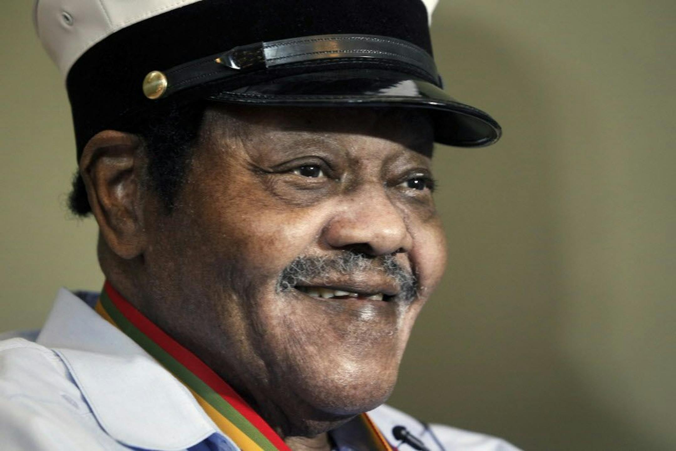 FILE - In this Dec. 20, 2013 file photo, legendary musician Fats Domino is named "Honorary Grand Marshall" of the Krewe of Orpheus, the star-studded Carnival club that traditionally parades the night before Mardi Gras in New Orleans. Domino, the amiable rock 'n' roll pioneer whose steady, pounding piano and easy baritone helped change popular music even as it honored the grand, good-humored tradition of the Crescent City, has died. He was 89. Mark Bone, chief investigator with the Jefferson Pari